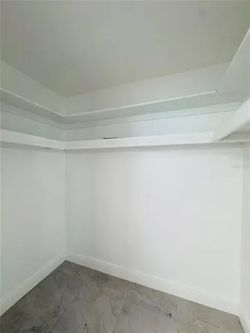 a bathroom with a granite countertop sink mirror vanity and toilet