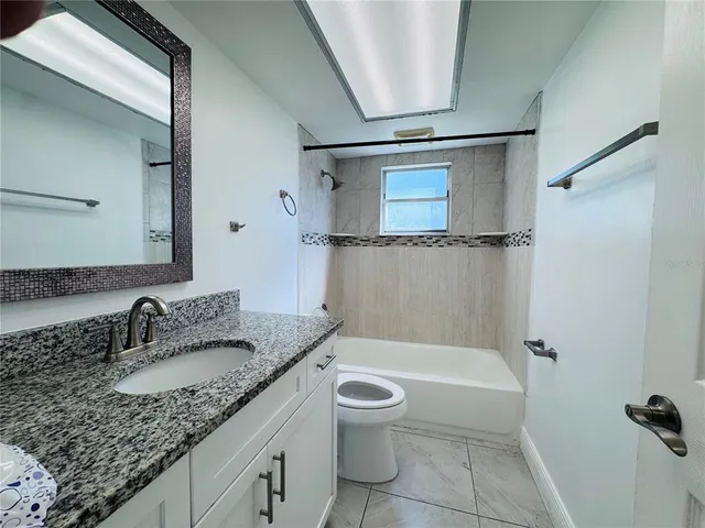 a view of a livingroom with an empty space and a window