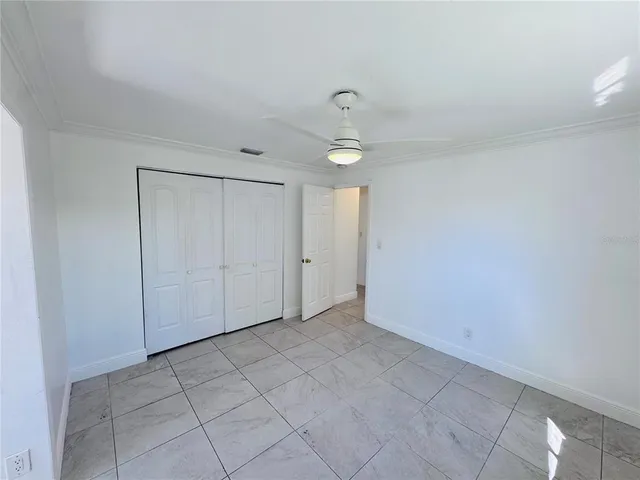 a view of hallway with a window and a refrigerator