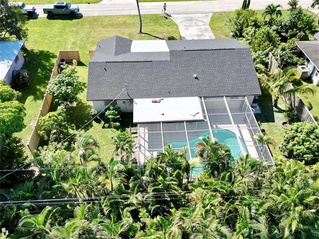 an aerial view of a house with a yard