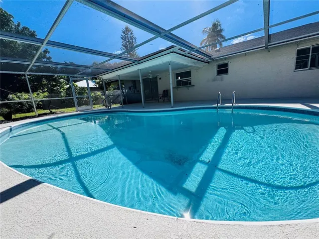 a view of a swimming pool with chairs