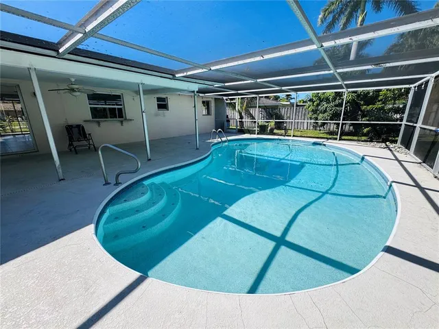 a view of a swimming pool with a patio