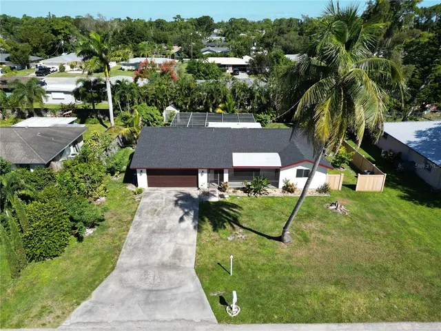 an aerial view of a house with garden space and street view