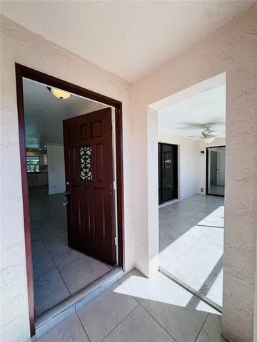 a view of hallway with view of bathroom