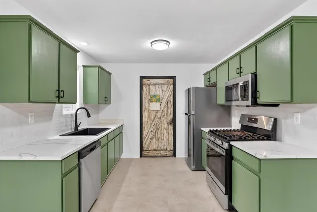 a kitchen that has a sink and a stove in it