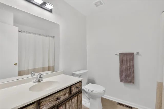 a bathroom with a sink toilet and a mirror