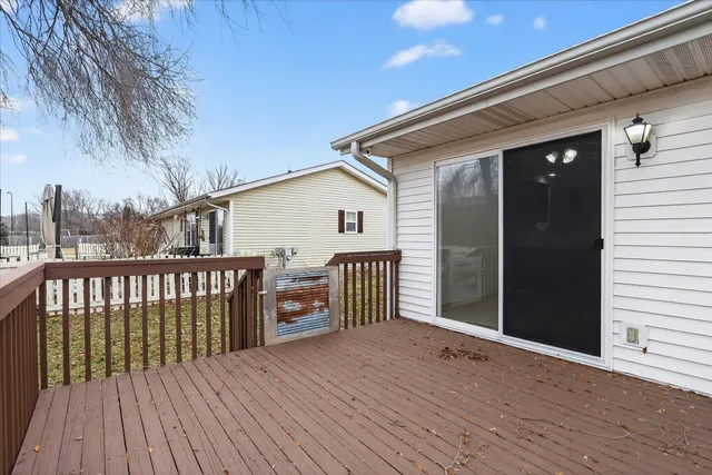 a view of a house with wooden deck