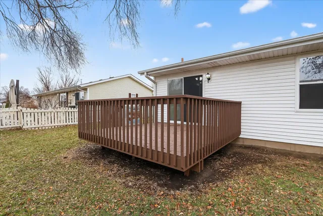 a view of backyard with deck and wooden floor