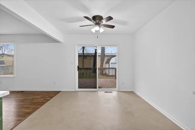 a view of a livingroom with a ceiling fan and window