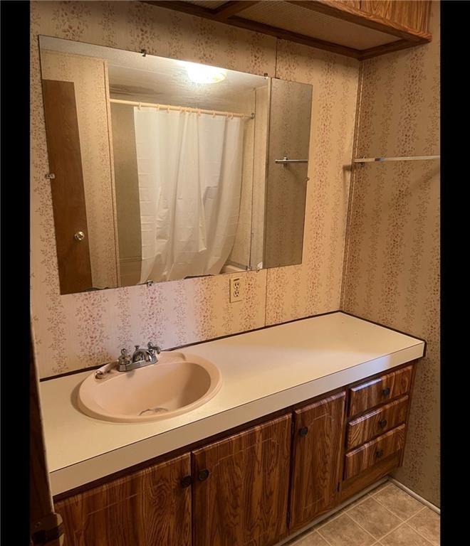 85 Honeysuckle Drive Southwest Cartersville, GA 30120 - Photo 19 of 22 a bathroom with a sink and a mirror