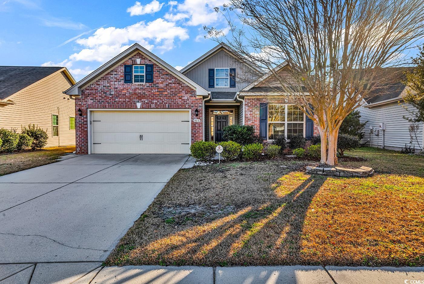 1612 Fairforest Court Conway, SC 29526 - Photo 1 of 40 View of front facade with brick siding, driveway, a front yard, and a garage