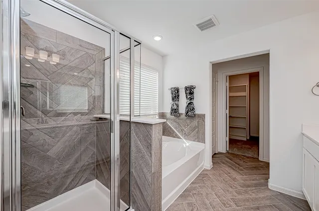 a bathroom with a bathtub and a shower