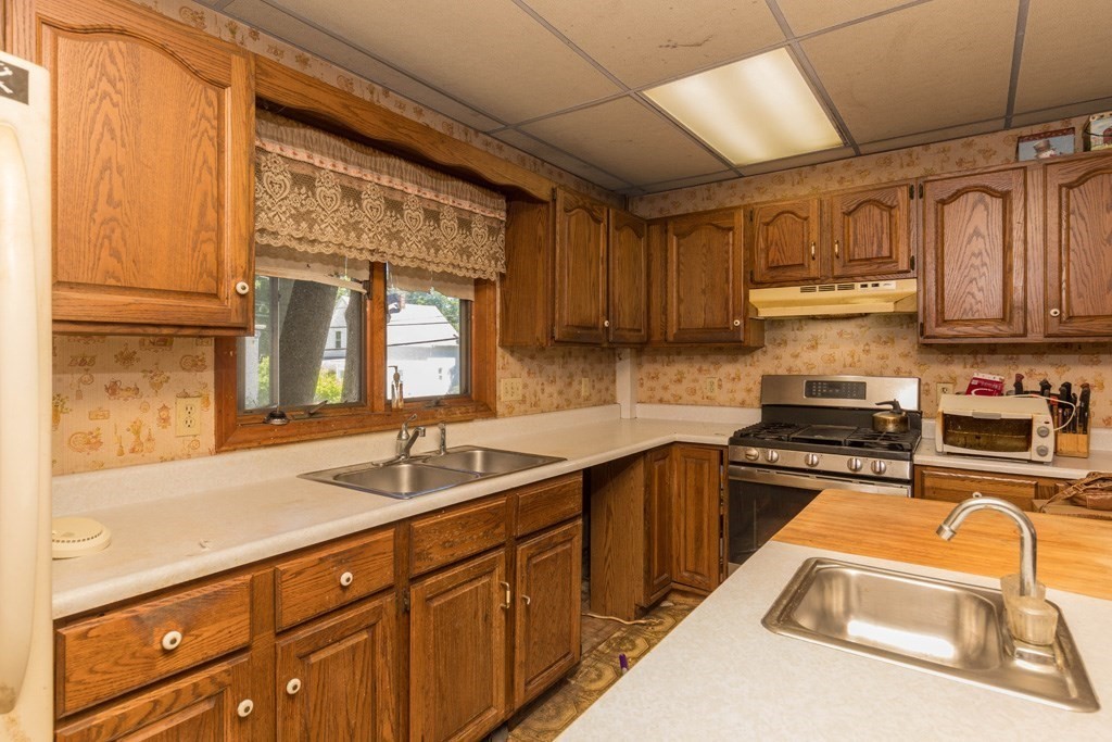 171 Sherman Street Gardner, MA 01440 - Photo 2 of 10 a kitchen with stainless steel appliances granite countertop a sink stove and cabinets