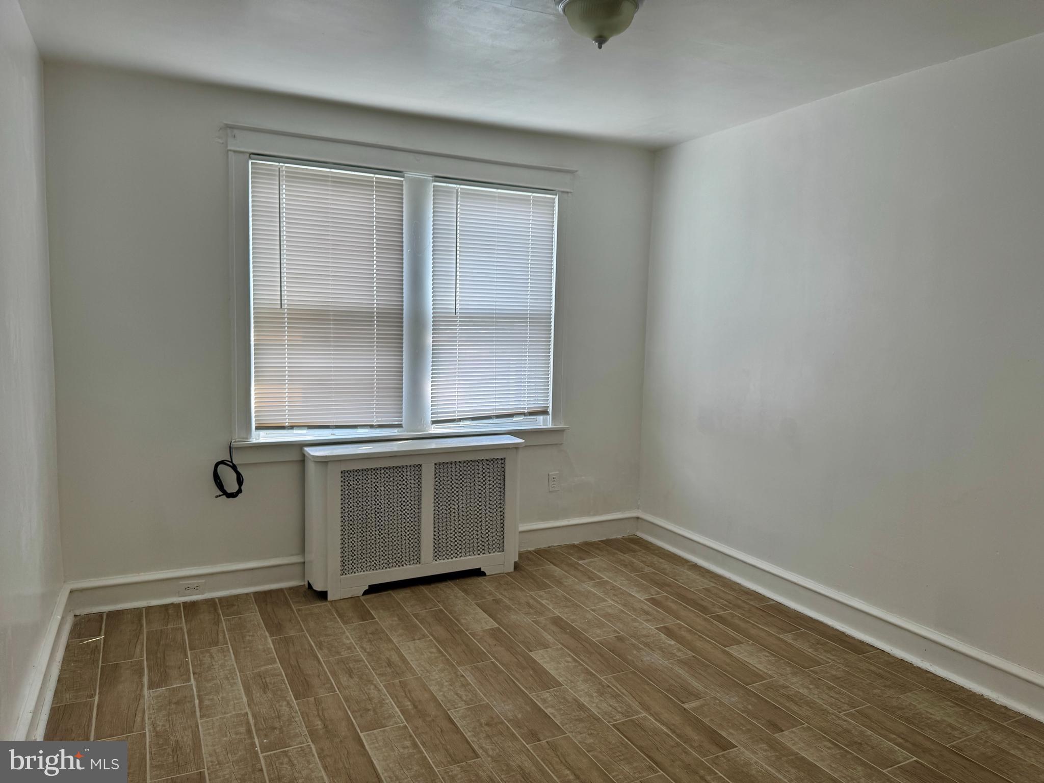 318 West Godfrey Avenue Philadelphia, PA 19120 - Photo 13 of 25 an empty room with wooden floor and windows