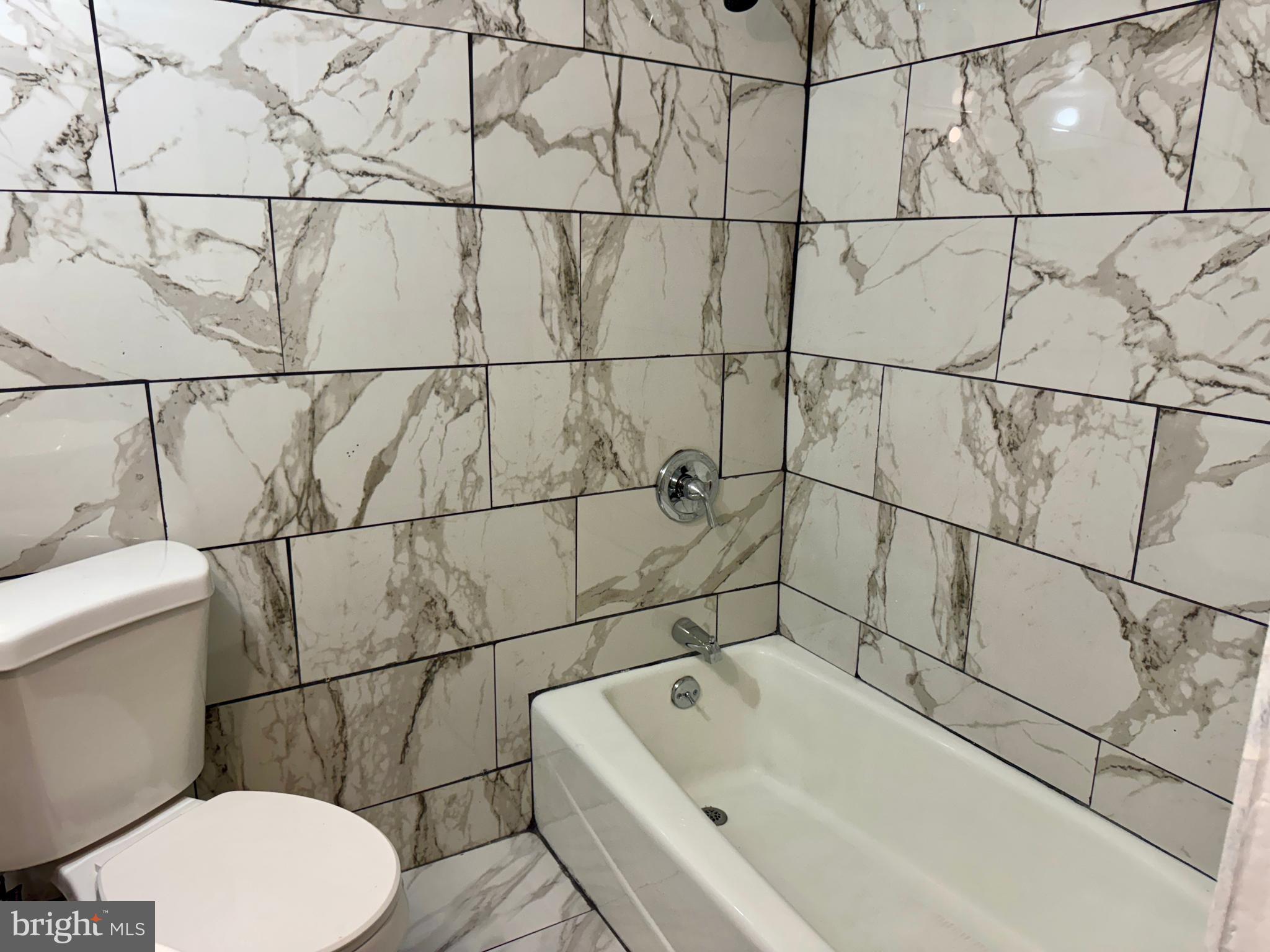 318 West Godfrey Avenue Philadelphia, PA 19120 - Photo 19 of 25 a bathroom with a bathtub and toilet