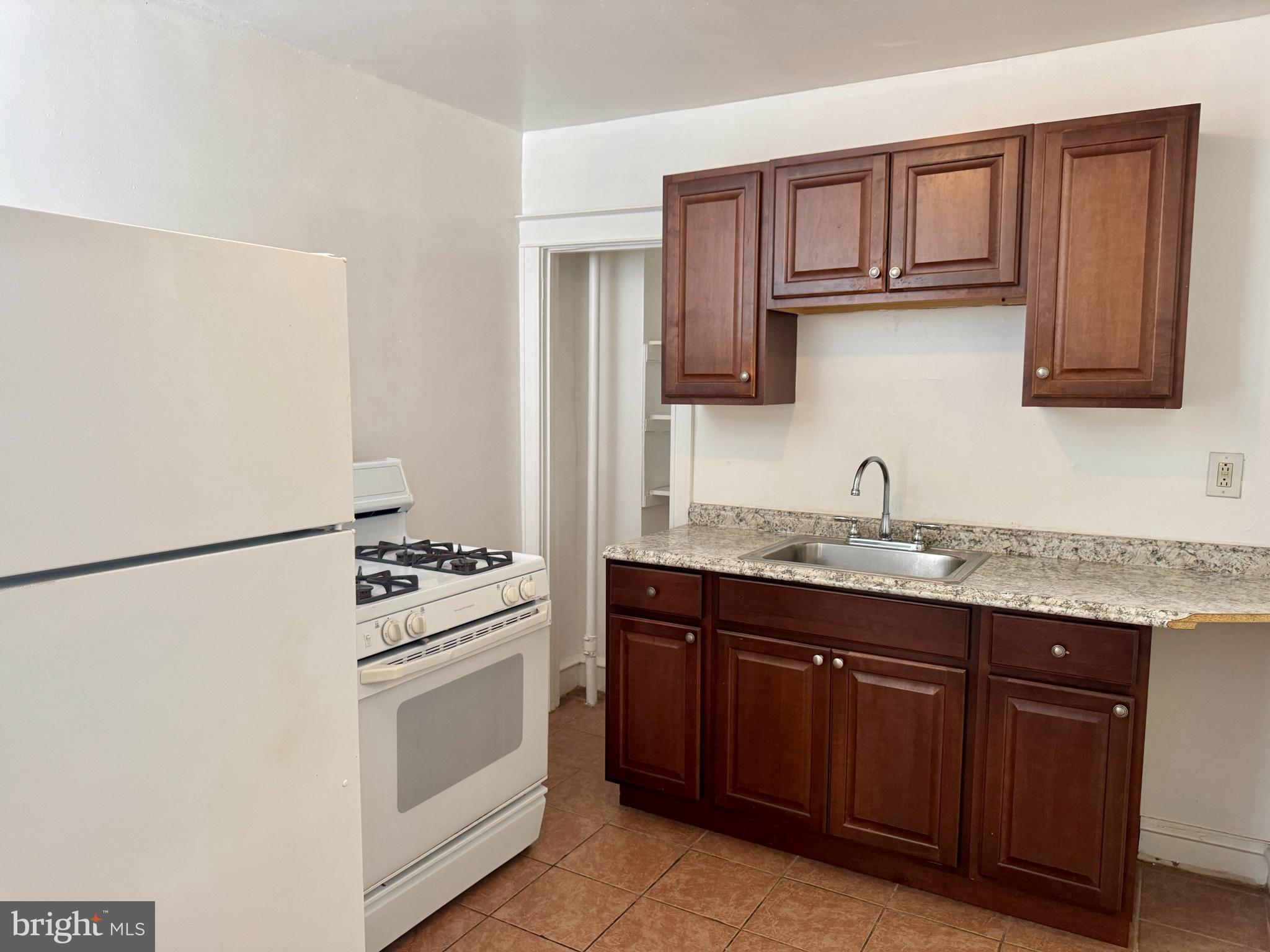 318 West Godfrey Avenue Philadelphia, PA 19120 - Photo 10 of 25 a kitchen with stainless steel appliances granite countertop a refrigerator stove a sink and dishwasher