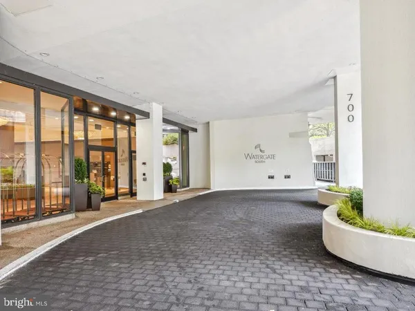 a living room with furniture and large windows