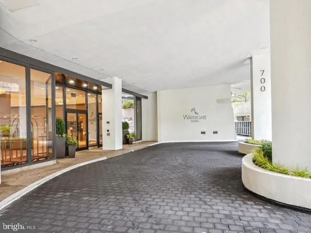 a living room with furniture and large windows