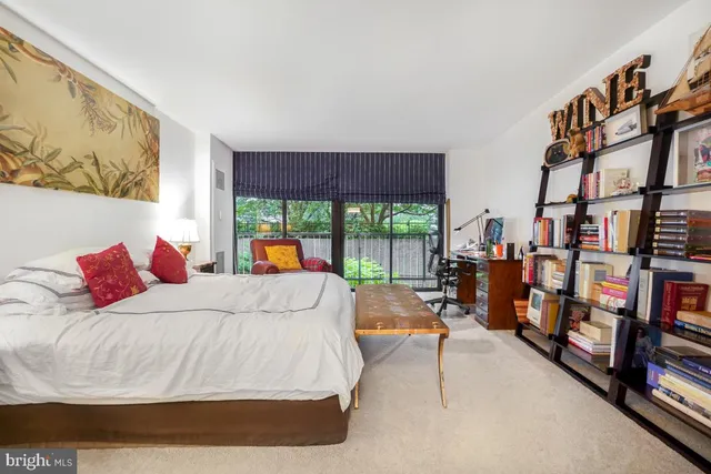a bedroom with a bed and a view of outdoor space