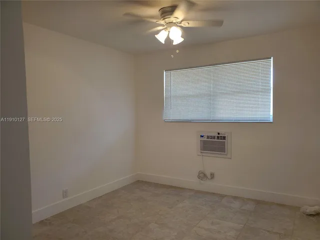 an empty room with a fan