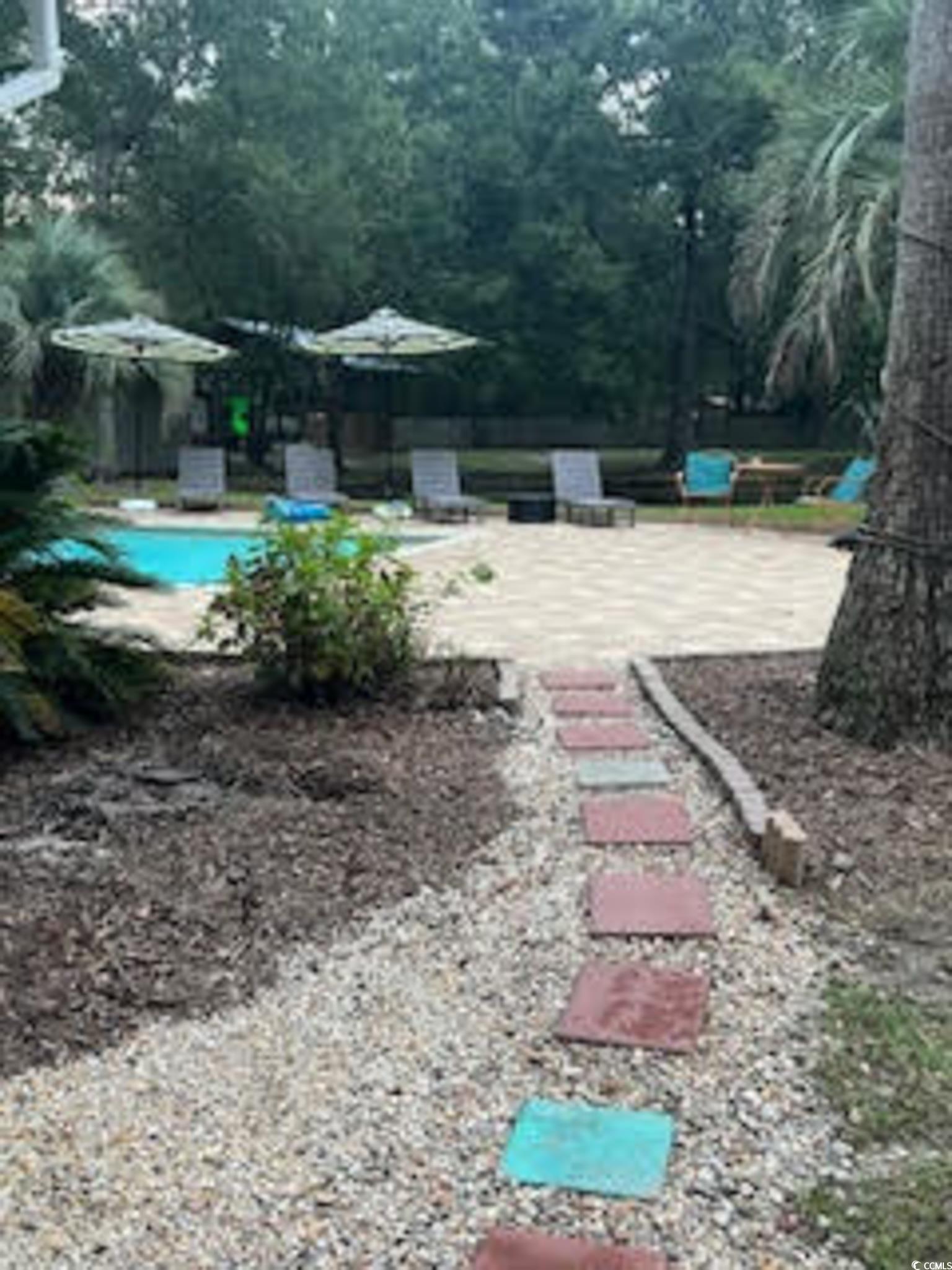 5588 Daybreak Road, Unit GUEST HOUSE Murrells Inlet, SC 29576 - Photo 17 of 18 View of yard with a patio area and an outdoor pool