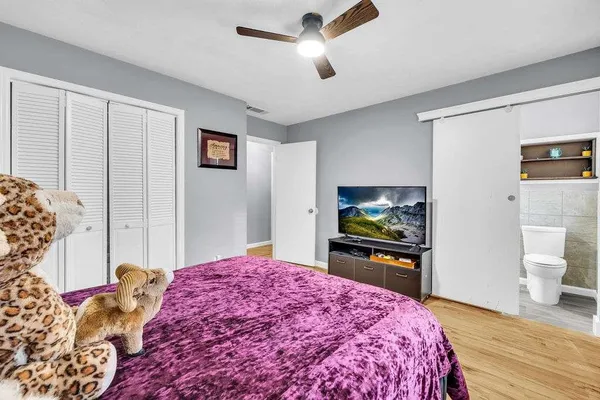 a spacious bedroom with a bed and a couch