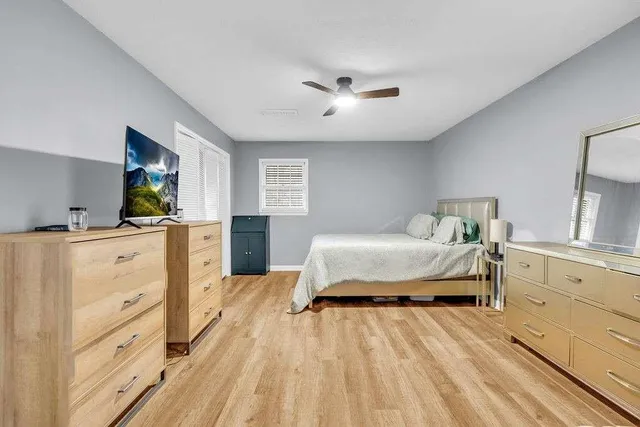 a bedroom with a bed and window