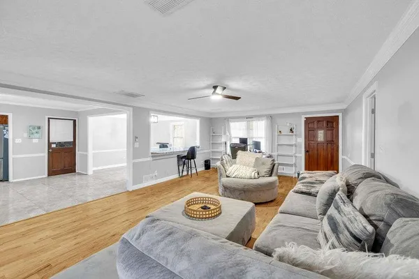 a living room with furniture and wooden floor