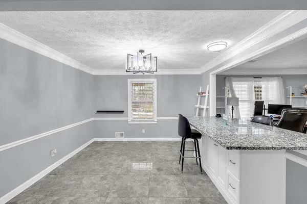 a view of a living room kitchen and a window