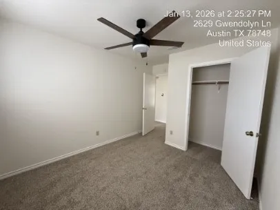 an empty room with closet and windows