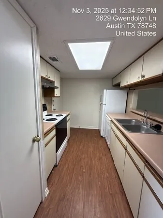 a kitchen with stainless steel appliances a refrigerator and a stove top oven