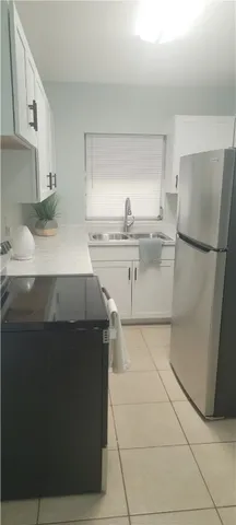 a kitchen with a cabinets and refrigerator