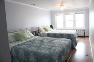 216 Broadway Milford, CT 06460 - Photo 12 of 18 a large bed sitting in a bedroom next to a window