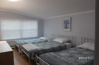 a bedroom with two beds and a window