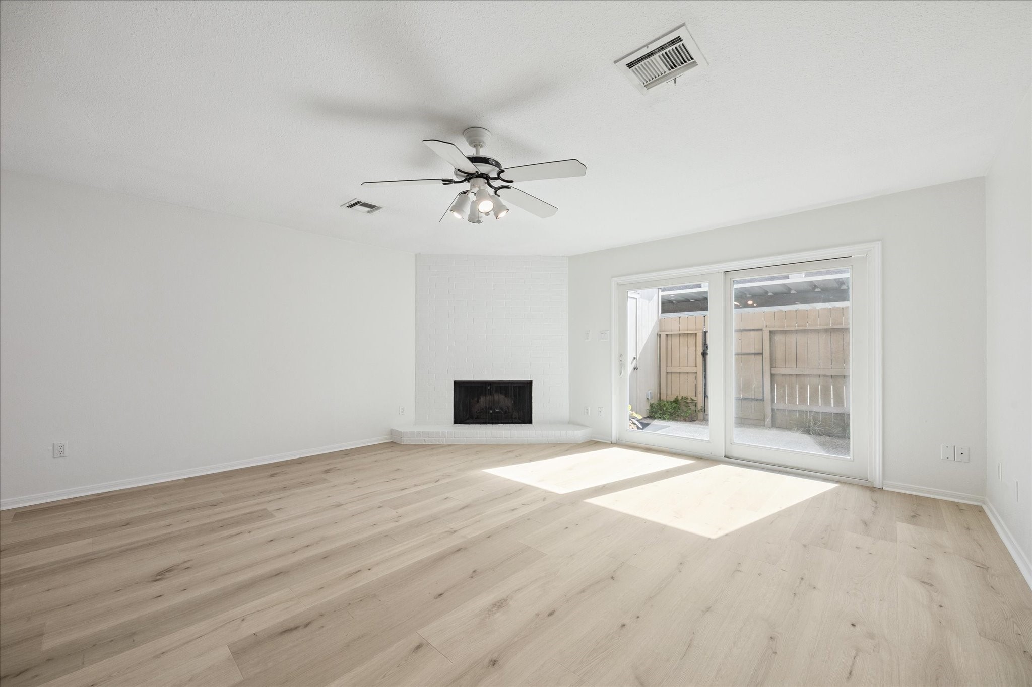 2515 Bering Drive, Unit 11 Houston, TX 77057 - Photo 12 of 26 a view of an empty room with a fireplace and a window