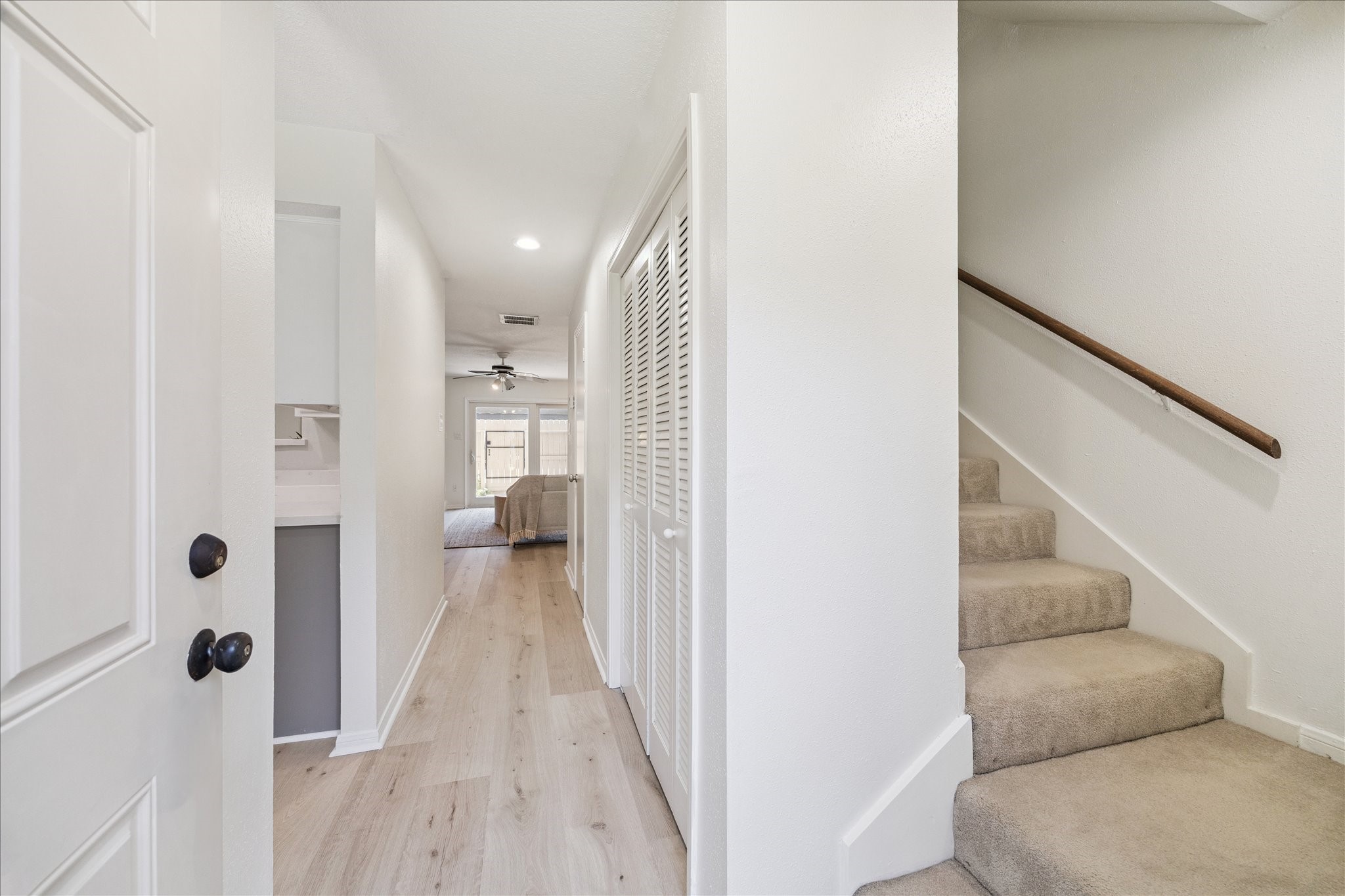 2515 Bering Drive, Unit 11 Houston, TX 77057 - Photo 13 of 26 a view of a hallway with wooden floor and staircase