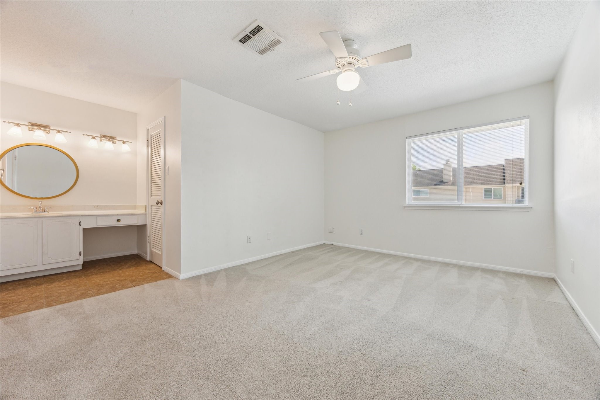 2515 Bering Drive, Unit 11 Houston, TX 77057 - Photo 15 of 26 an empty room with windows and fan