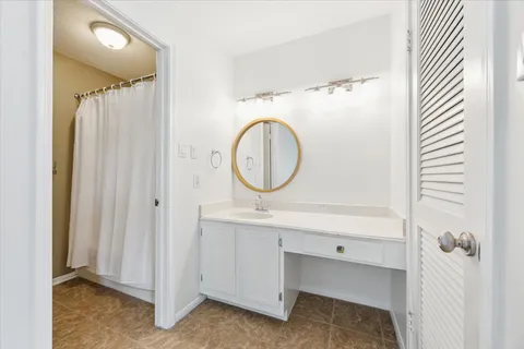 a bathroom with a sink a mirror and a shower
