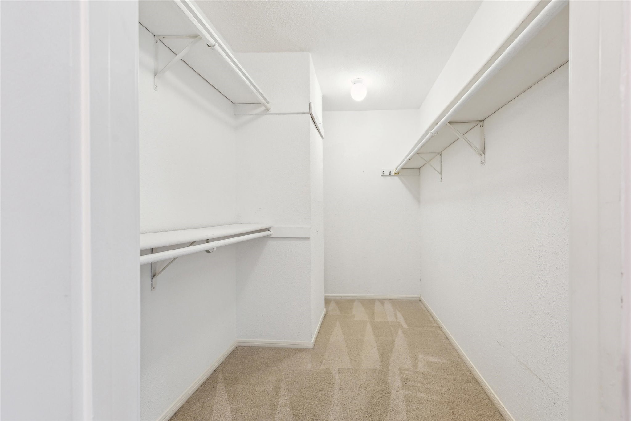 2515 Bering Drive, Unit 11 Houston, TX 77057 - Photo 18 of 26 a view of walk in closet with empty racks