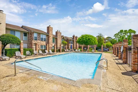 a view of swimming pool with outdoor seating and plants