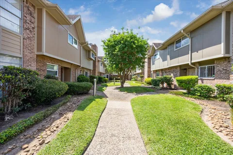 a view of a building with a yard