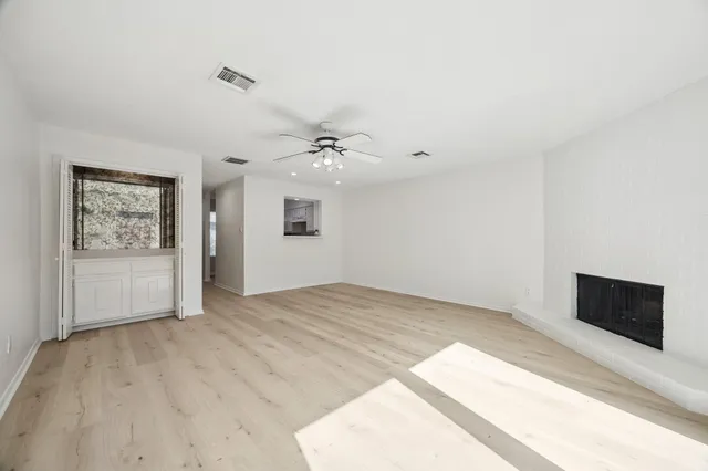 a view of an empty room and a ceiling fan