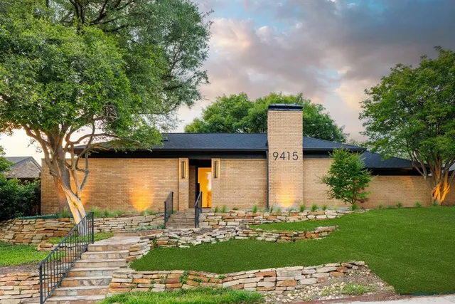 a view of a lake with a big yard and large trees