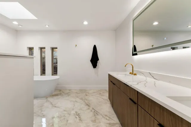 a bathroom with a double vanity sink and mirror