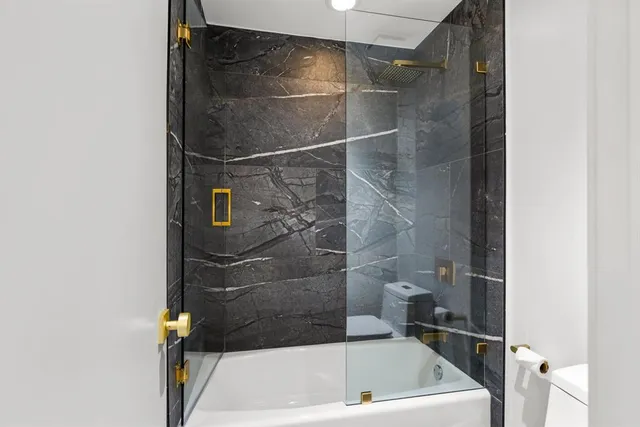 a bathroom with a bath tub and a shower