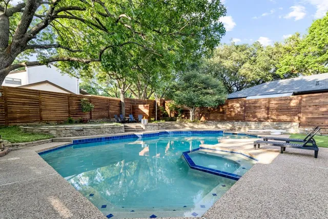 a view of a swimming pool with lounge chairs