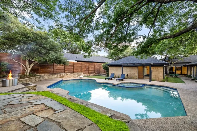 a view of a patio with swimming pool table and chairs