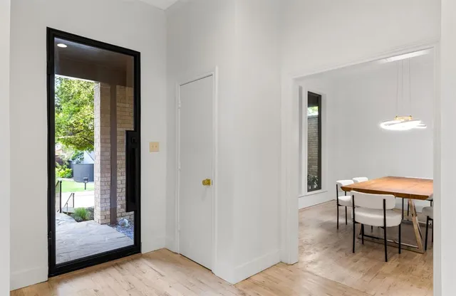 a view of a room with a table and chairs