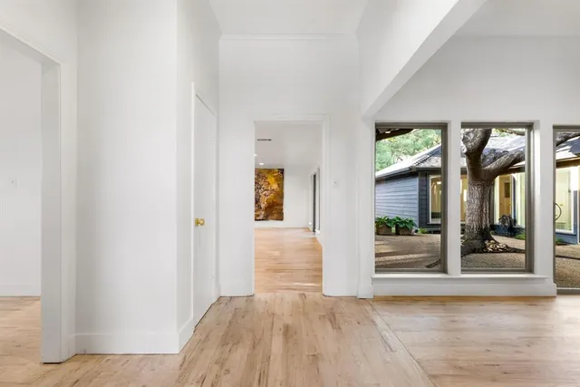a view of an entryway with wooden floor and door