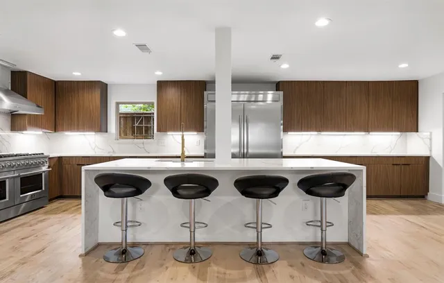 a kitchen with a stove a refrigerator and a sink